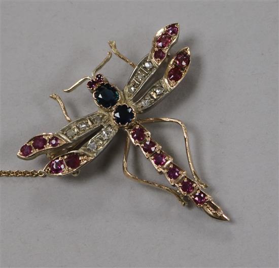 An Edwardian yellow metal, ruby, sapphire and diamond dragonfly brooch, 42mm.